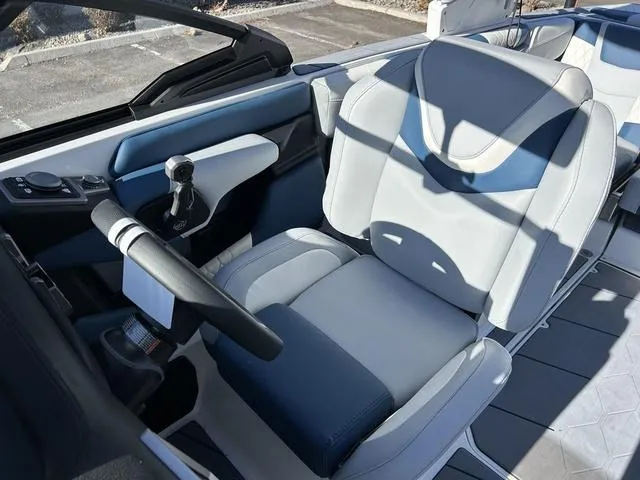 Slide: The Image of 2024 Malibu M220 boat interior with captain's chair and steering wheel. - 9