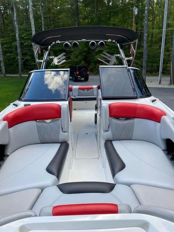 Slide: The Image of 2015 MasterCraft X55 boat with red and gray interior, open seating area. - 5