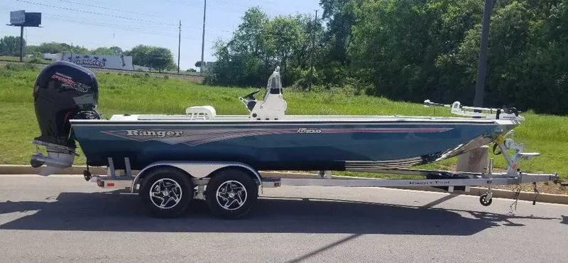The Image of 2024 Ranger RB210 boat on a trailer, parked outdoors. - 0
