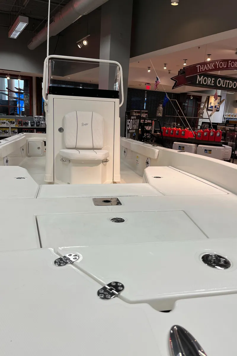 Slide: The Image of 2024 Ranger 2360 Bay boat interior on display in a showroom. - 3