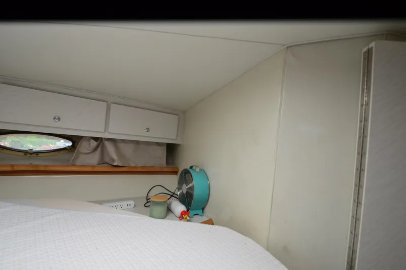 Slide: The Image of Interior cabin of 1996 Wellcraft Portofino 43 with storage and porthole. - 13