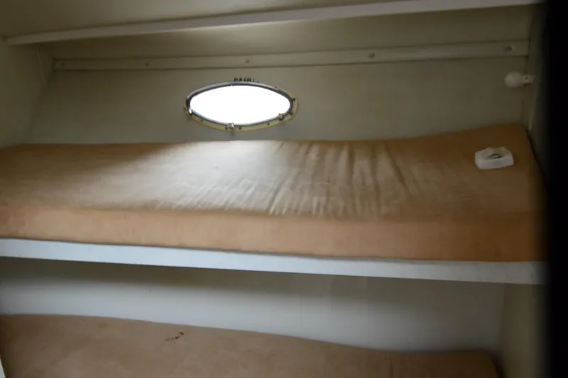 Slide: The Image of Interior of 1996 Wellcraft Portofino 43 with bunk beds and porthole window. - 14