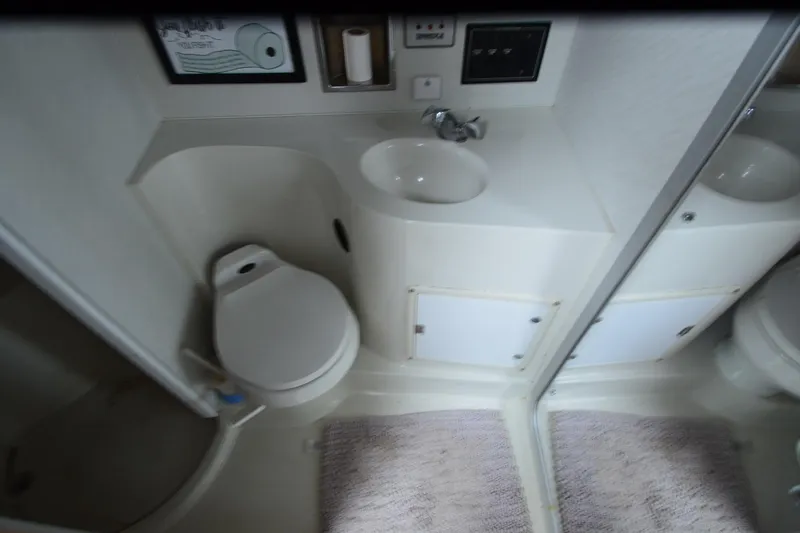 Slide: The Image of Bathroom interior of 1996 Wellcraft Portofino 43 yacht, featuring toilet and sink. - 15