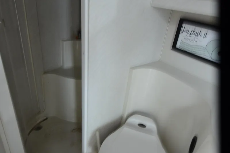 Slide: The Image of Bathroom interior of 1996 Wellcraft Portofino 43 yacht, featuring shower and toilet. - 16
