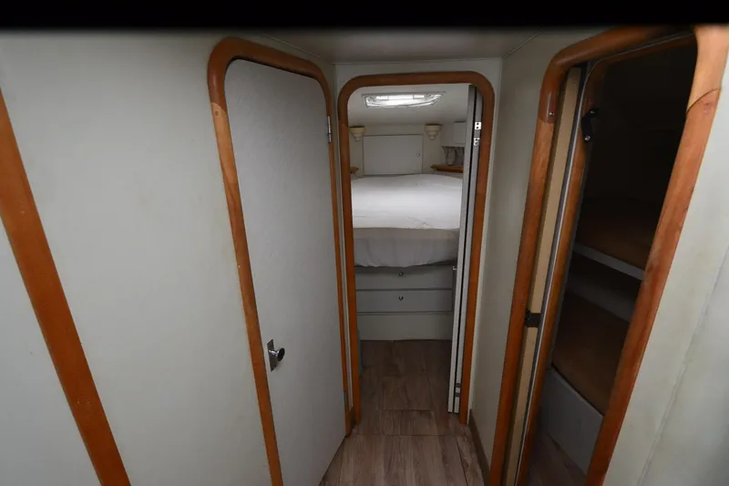 Slide: The Image of Interior of 1996 Wellcraft Portofino 43 yacht, featuring cozy cabin and wooden accents. - 17