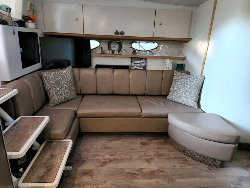 Slide: The Image of Interior of 1996 Wellcraft Portofino 43 yacht with beige leather seating and wooden flooring. - 18