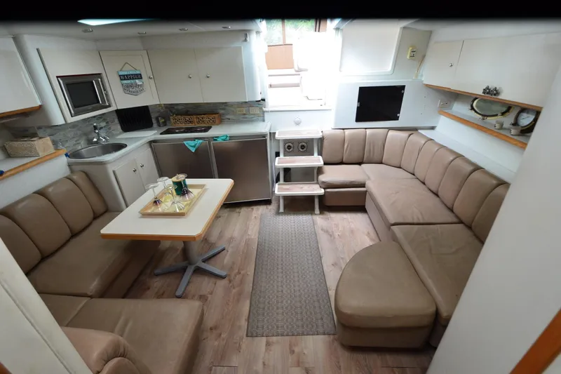 Slide: The Image of Interior of 1996 Wellcraft Portofino 43 yacht with cozy seating and modern kitchen area. - 19