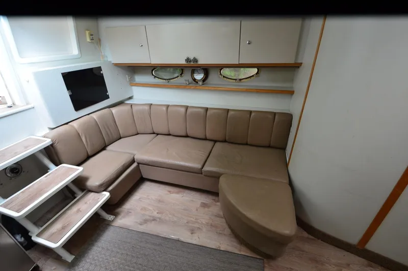 Slide: The Image of Interior of 1996 Wellcraft Portofino 43 yacht with beige seating and wooden accents. - 20