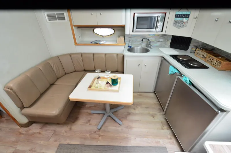 Slide: The Image of Interior of 1996 Wellcraft Portofino 43 yacht with kitchenette and seating area. - 21