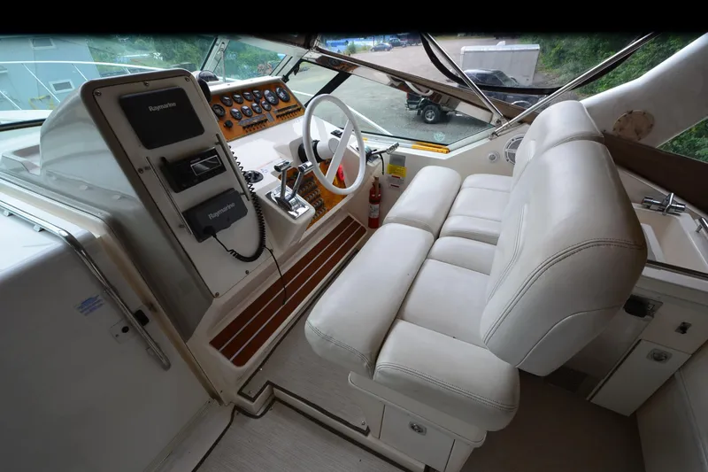 Slide: The Image of Interior cockpit of 1996 Wellcraft Portofino 43 with steering wheel and control panel. - 24