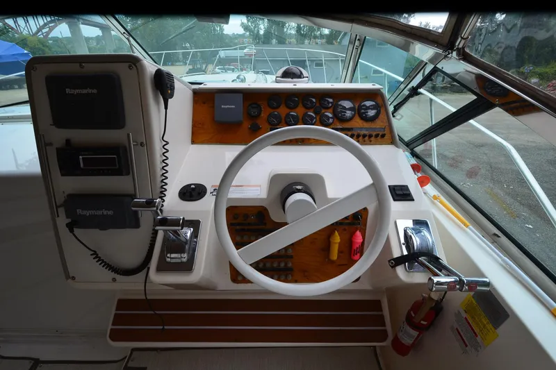 Slide: The Image of 1996 Wellcraft Portofino 43 helm with steering wheel, gauges, and navigation equipment. - 27