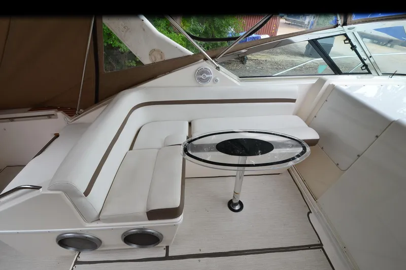 Slide: The Image of 1996 Wellcraft Portofino 43 interior with white seating and glass table. - 28