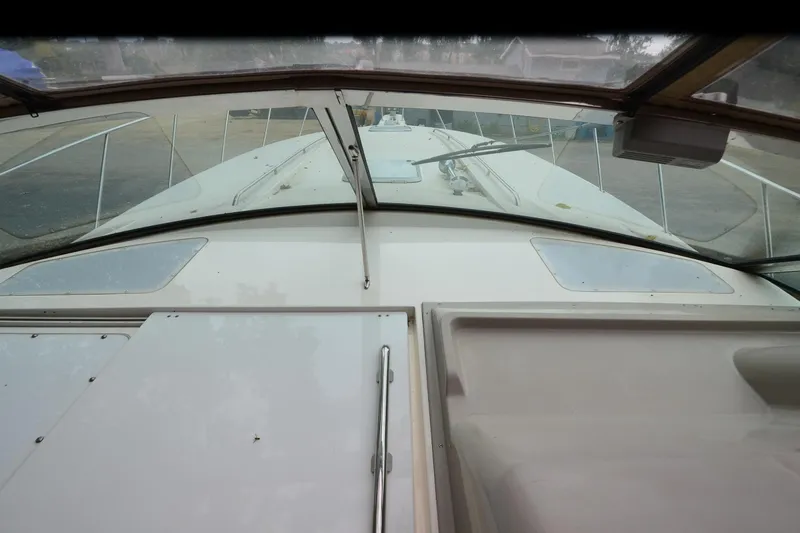 Slide: The Image of 1996 Wellcraft Portofino 43 boat deck view with windshield and railing. - 30