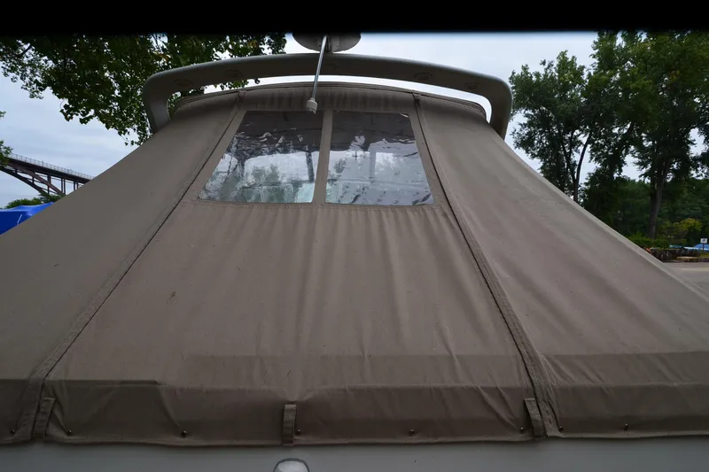 Slide: The Image of 1996 Wellcraft Portofino 43 boat with beige canvas cover, docked outdoors. - 7