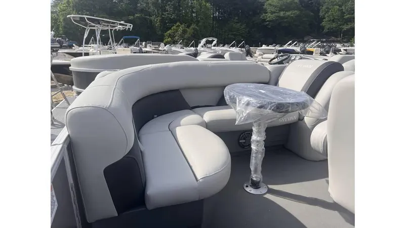Slide: The Image of 2024 Sylvan 818 Mirage Cruise boat with plush seating and a small table. - 5