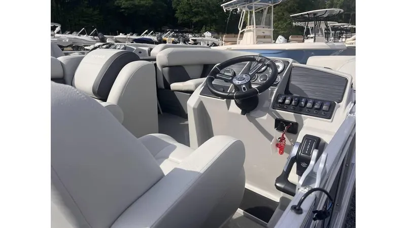 Slide: The Image of 2024 Sylvan 818 Mirage Cruise boat interior with steering wheel and control panel. - 6