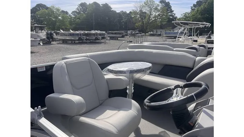 Slide: The Image of 2024 Sylvan 818 Mirage Cruise boat interior with seating and steering wheel. - 7