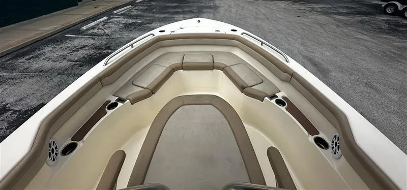 Slide: The Image of 2021 Scout 215 XSF boat interior with cushioned seating and cup holders. - 5