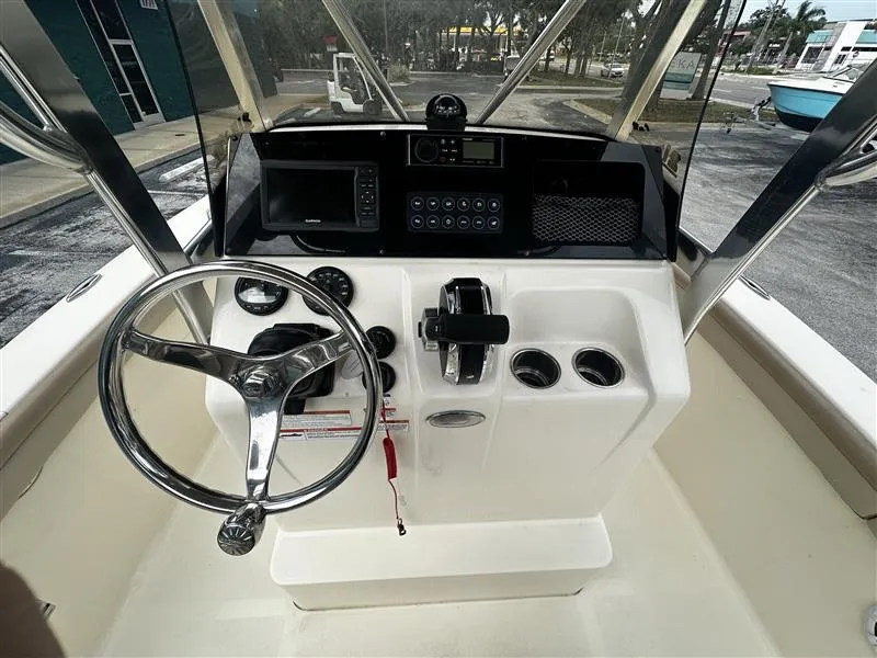 Slide: The Image of 2021 Scout 215 XSF boat dashboard with steering wheel and controls. - 7