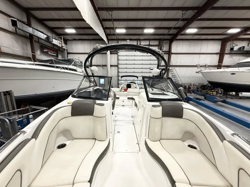 Slide: The Image of 2014 Yamaha Boats 242 Limited S interior in a warehouse, featuring spacious seating and sleek design. - 16