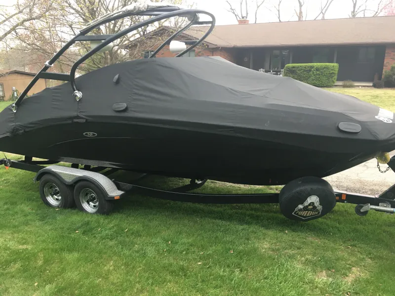 Slide: The Image of 2014 Yamaha Boats 242 Limited S covered on trailer in yard. - 22