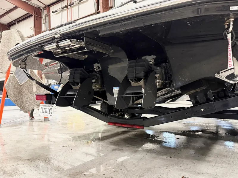 Slide: The Image of 2014 Yamaha Boats 242 Limited S underside view in a warehouse setting. - 4