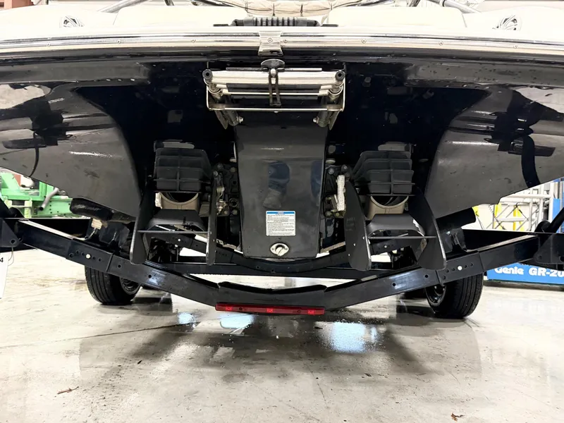 Slide: The Image of 2014 Yamaha Boats 242 Limited S underside view, showcasing dual engines and trailer. - 6