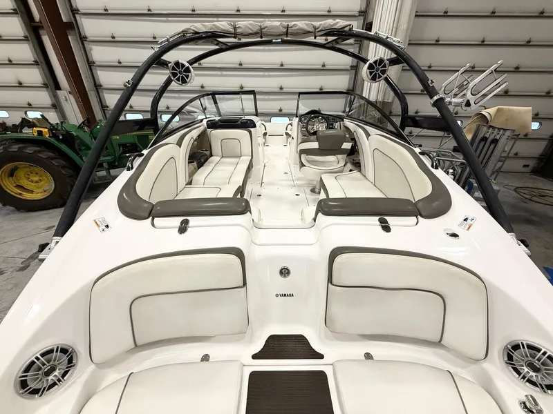 Slide: The Image of 2014 Yamaha Boats 242 Limited S interior with white seating and sleek design. - 9