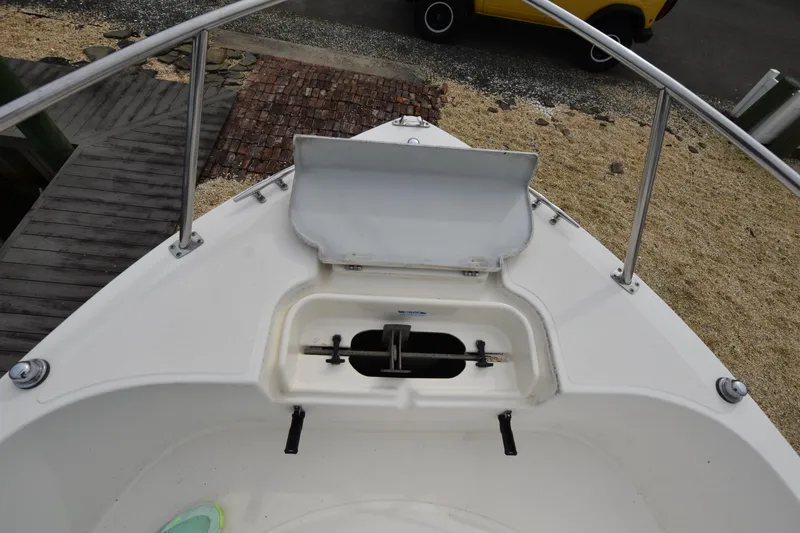Slide: The Image of Bow view of a 1994 Pursuit 2350 boat with open anchor locker. - 15