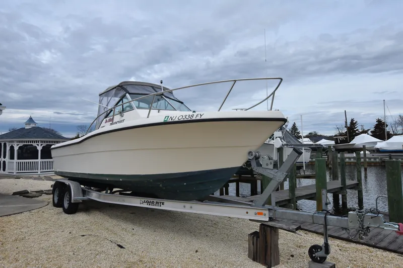Slide: The Image of 1994 Pursuit 2350 boat on trailer at marina, ready for launch. - 4