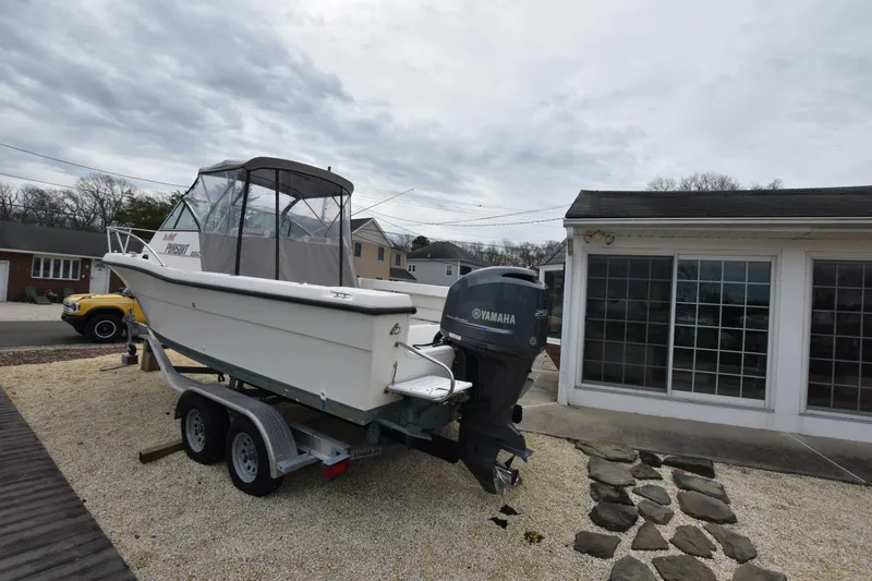 Slide: The Image of 1994 Pursuit 2350 boat on trailer with Yamaha outboard motor. - 6