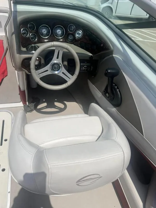 Slide: The Image of 2016 Crownline Boats 21SS cockpit with steering wheel and control panel. - 10