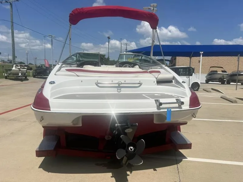 Slide: The Image of 2016 Crownline Boats 21SS, rear view, in a parking lot with other boats. - 4