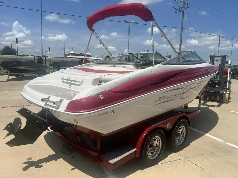 Slide: The Image of 2016 Crownline Boats 21SS on trailer, red and white exterior, sunny day. - 5
