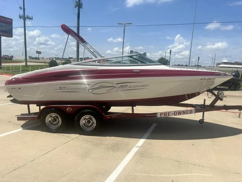 Slide: The Image of 2016 Crownline Boats 21SS on trailer, pre-owned, red and white, parked outdoors. - 6