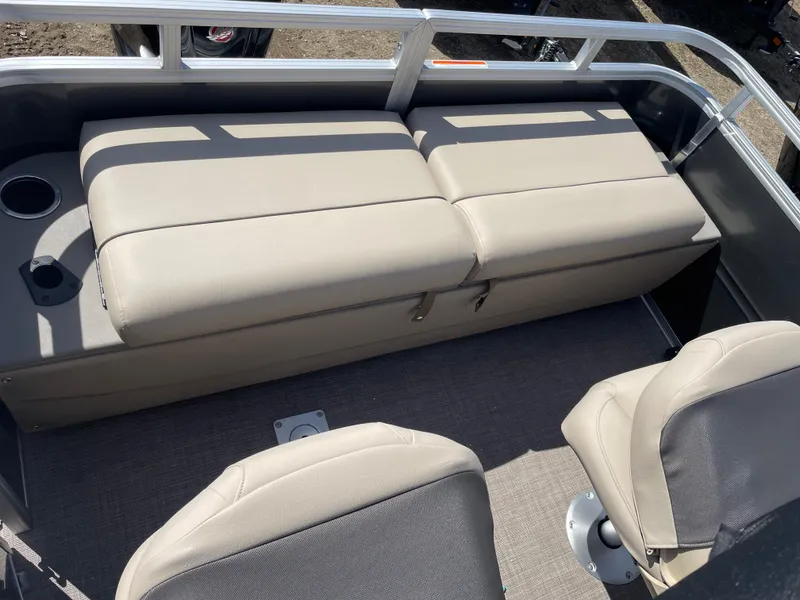 Slide: The Image of 2024 Sun Tracker Fishin' Barge 22 DLX seating area with beige cushions and cup holders. - 15