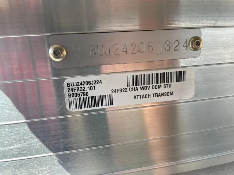 Slide: The Image of 2024 Sun Tracker Fishin' Barge 22 DLX hull identification number (HIN) plate and barcode. - 3