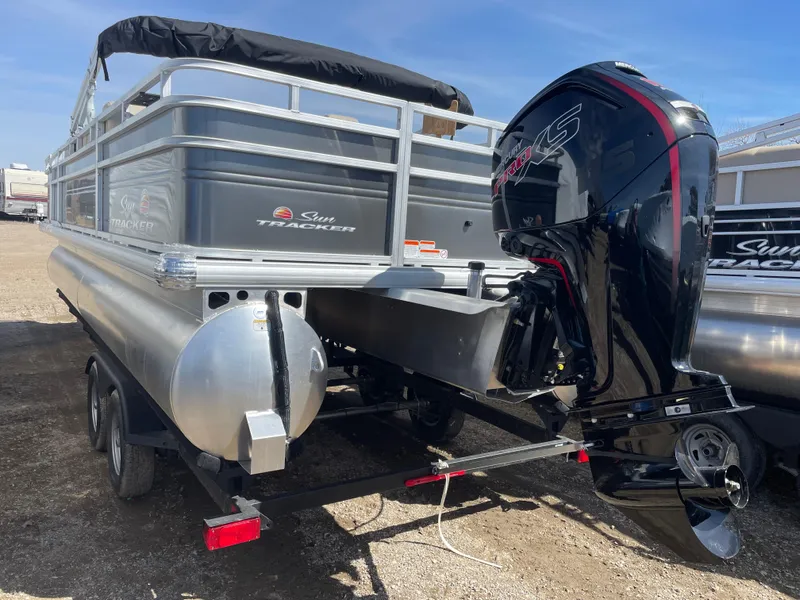 Slide: The Image of 2024 Sun Tracker Fishin' Barge 22 DLX pontoon boat with outboard motor. - 5