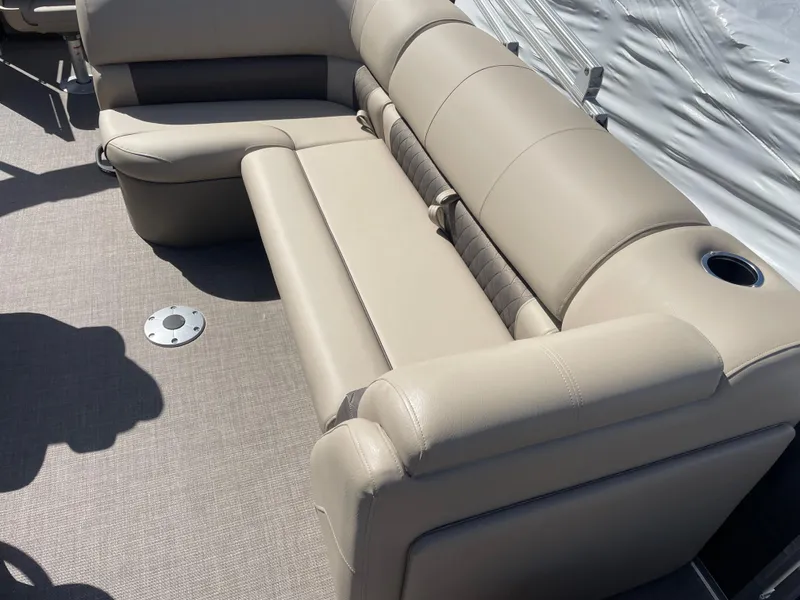 Slide: The Image of 2024 Sun Tracker Fishin' Barge 22 DLX interior seating with beige upholstery. - 9