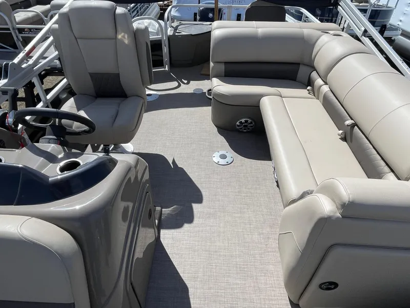 Slide: The Image of 2023 Sun Tracker SportFish 20 DLX interior with plush seating and steering console. - 7