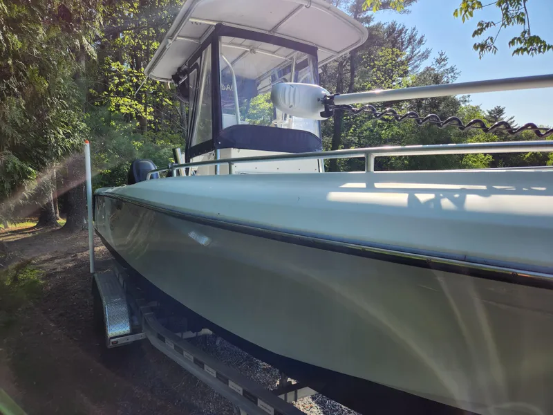 Slide: The Image of 2006 Blue Fin Pro Fish C/C boat on trailer, surrounded by trees. - 11