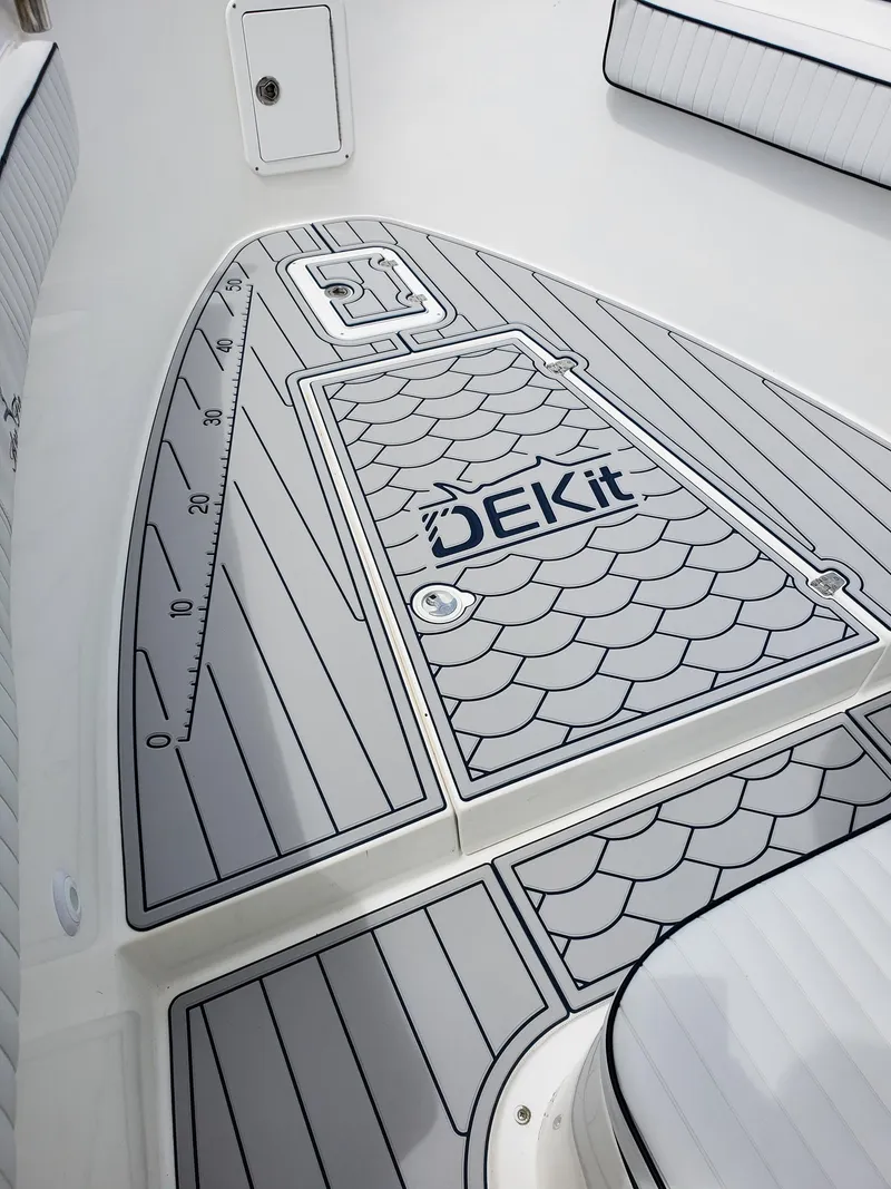 Slide: The Image of 2006 Blue Fin Pro Fish C/C boat deck with DEKit flooring and measurement scale. - 17