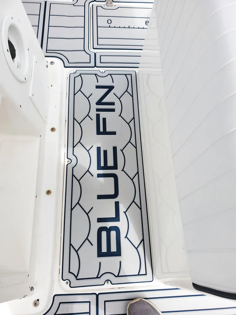 Slide: The Image of 2006 Blue Fin Pro Fish C/C boat deck with logo and textured design. - 22
