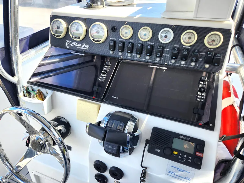 Slide: The Image of 2006 Blue Fin Pro Fish C/C boat dashboard with gauges and navigation equipment. - 23