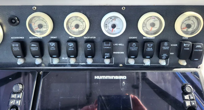Slide: The Image of Control panel of a 2006 Blue Fin Pro Fish C/C boat with gauges and switches. - 24