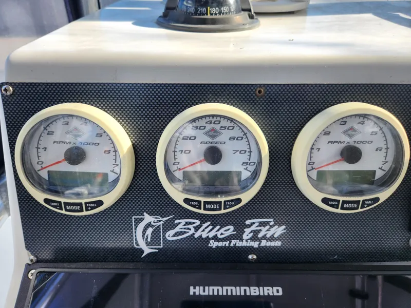 Slide: The Image of Dashboard of 2006 Blue Fin Pro Fish C/C boat with gauges and Humminbird device. - 25