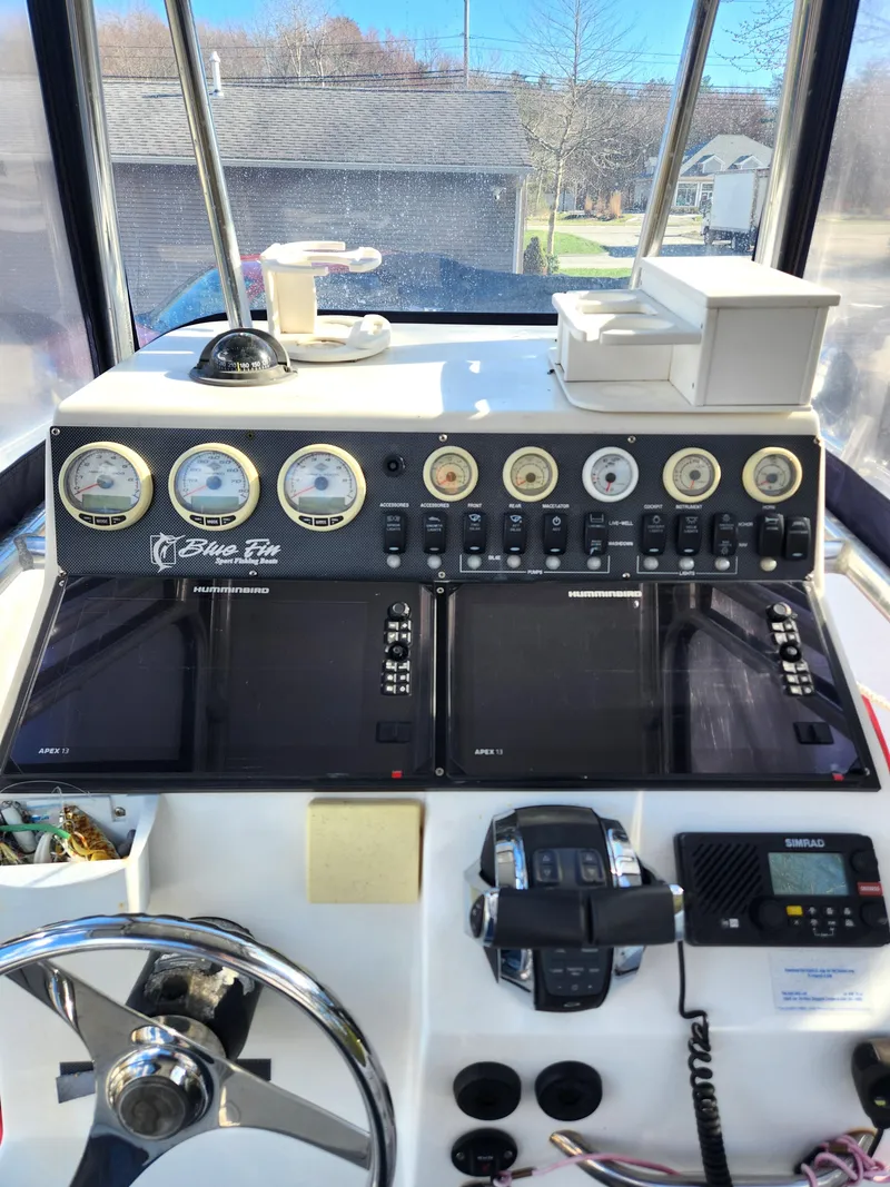 Slide: The Image of 2006 Blue Fin Pro Fish C/C boat dashboard with gauges and controls. - 26