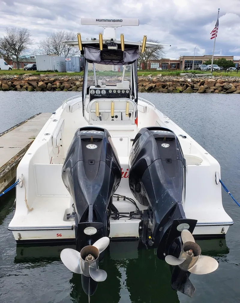 Slide: The Image of 2006 Blue Fin Pro Fish C/C boat with dual outboard motors docked in a marina. - 5