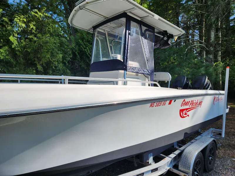 Slide: The Image of 2006 Blue Fin Pro Fish C/C boat on trailer, side view with canopy, in wooded area. - 6