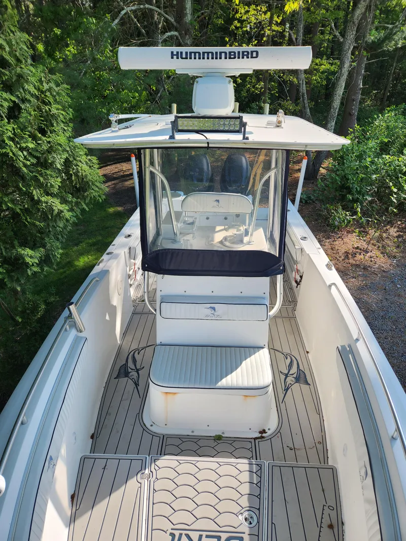 Slide: The Image of 2006 Blue Fin Pro Fish C/C boat with Humminbird equipment, docked in a wooded area. - 7